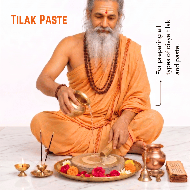 An elderly bearded man in an orange robe sits cross-legged while pouring liquid from a brass pot into a stone grinder on a tray decorated with flowers. The scene includes the text 'TILAK PASTE' and a note explaining use for preparing types of tilak and paste, with brass lamps and a brass vessel nearby on a light background.