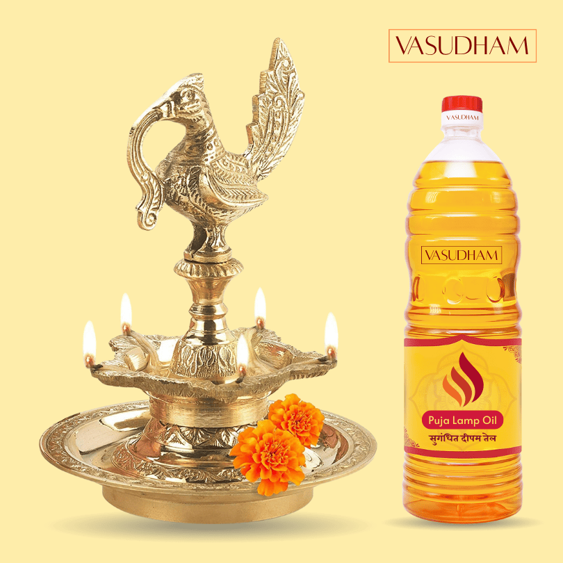 Decorative oil lamp with lit candles and a bottle of Vasudham Puja Lamp Oil on a yellow background.