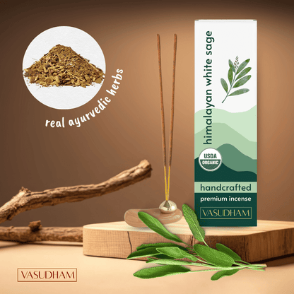 Himalayan white sage incense with packaging and herbs on a wooden surface