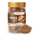 Jar of Yasudham sandalwood dhoop powder with a wooden bowl filled with powder on a white background