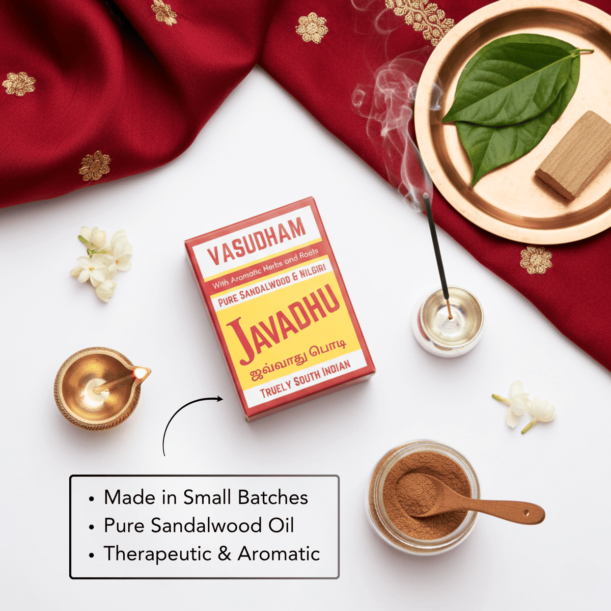 Vasudham Javadhu sandalwood product with incense sticks, leaves, and oil on a white background