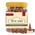Jar of Vasudham incense cones with a yellow lid and visible label.