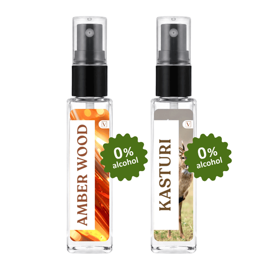 Two clear glass perfume spray bottles with black pumps, labeled Amber Wood and Kasturi, shown side by side on a white background with green '0% alcohol' badges.