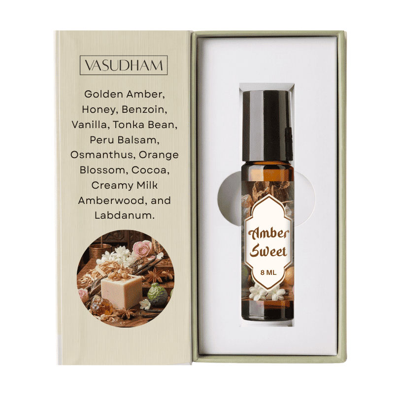 A 8 ml amber roll-on bottle from the brand VASUDHAM, presented inside its light beige packaging next to an outer box detailing the ingredients, including Golden Amber, Honey, and Vanilla.