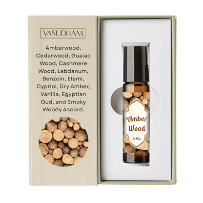 Vasudham Amber Wood 8ml rollerball perfume oil in a clear glass bottle with a black cap, presented in its beige gift box next to a white insert card.