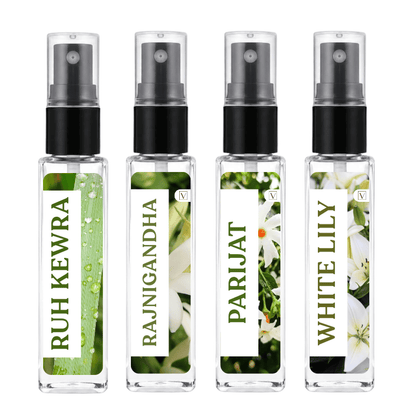 Four small clear spray bottles with black pump tops arranged side by side on a white background. Each bottle has a vertical label with green text and floral/leaf imagery: 'RUH KEWRA', 'RAJNIGANDHA', 'PARIJAT', and 'WHITE LILY'.