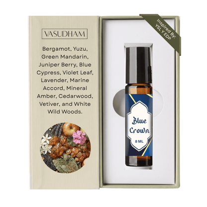 Vasudham Blue Crown 8ml rollerball oil in its original packaging, featuring a beige textured box with scent notes and an illustration, next to the amber glass bottle with a navy blue label.