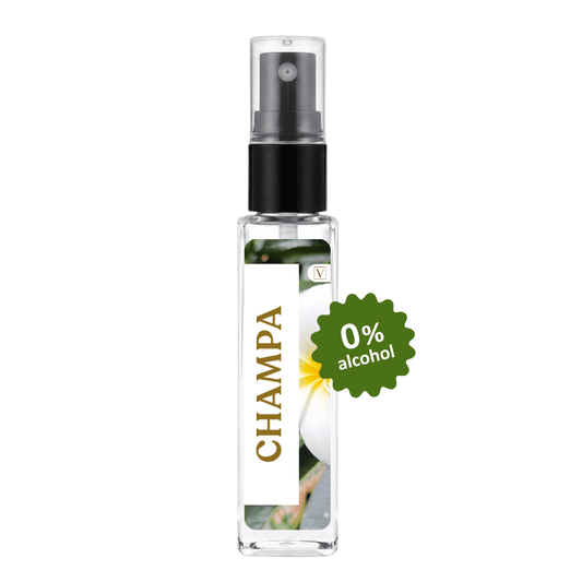 A clear glass spray bottle labeled CHAMPA with a black pump, shown on a plain white background with a green '0% alcohol' badge overlaid on the right side.
