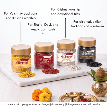 Four jars of vasudham chandan tilak with yellow caps arranged on marble plate with different color chandan tilak inside