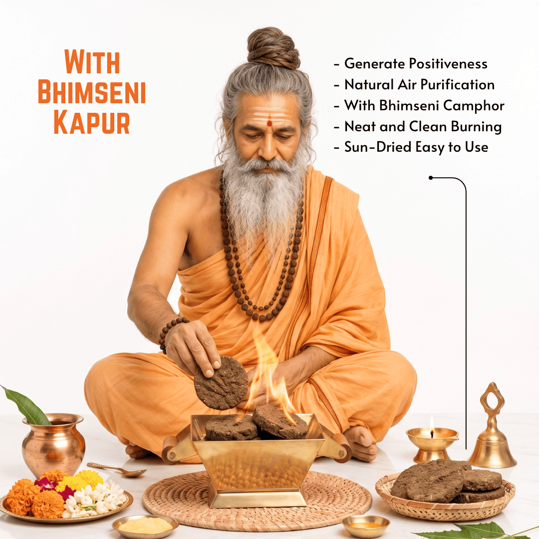 An elderly man with a long gray beard and hair in a bun sits cross-legged on a white studio background, performing a ritual with Bhimseni kapur. He is dressed in orange robes and is surrounded by offerings, a brass incense burner with visible flames, decorative brass vessels, and text overlays describing the product benefits.