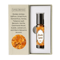 Vasudham Dush Gold 8ml roll-on bottle with amber liquid, presented in a white box next to its beige packaging insert detailing the scent notes and ingredients.