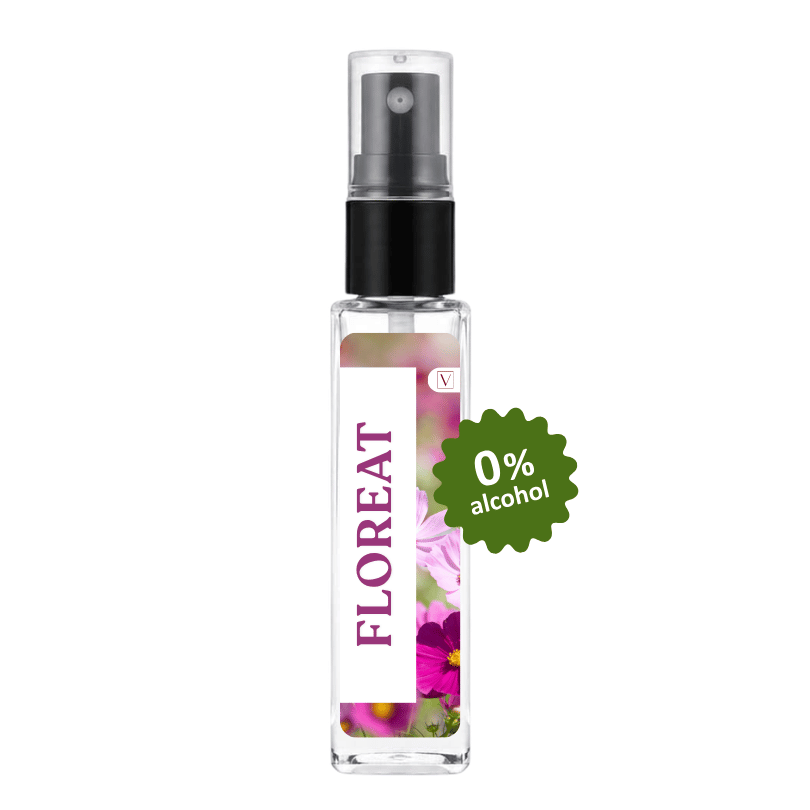 A clear glass perfume spray bottle with a black pump and a white label featuring purple text reading 'FLOREAT' and floral artwork. A green badge on the right says '0% alcohol'.