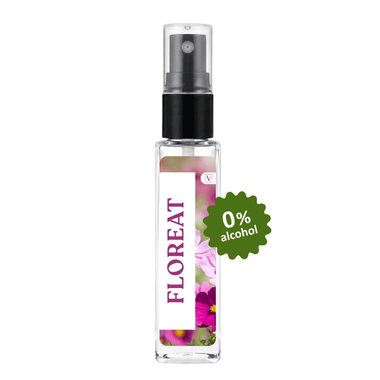 A clear glass perfume spray bottle with a black pump and a white label featuring purple text reading 'FLOREAT' and floral artwork. A green badge on the right says '0% alcohol'.