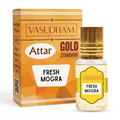 Vasudham Attar Gold Standard Fresh Mogra perfume bottle and its orange packaging box on a white background.