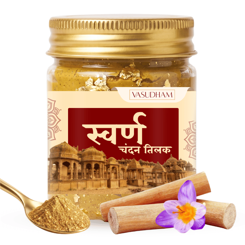 A jar of Vasudham Swarn Chandan Tilak (gold body paint) with a gold-colored lid, shown alongside a gold spoon filled with the powder, wooden sticks, and a purple flower on a white background.
