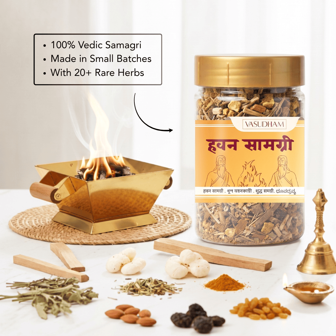 A jar of vasudham havan samagri herbal powder shown next to a small brass incense burner with visible flames, along with scattered herbs, almonds, raisins, and other ingredients on a white surface.