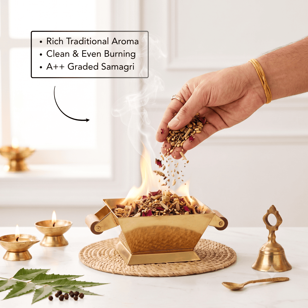 A brass samagri incense burner with a flame burning inside, shown with a hand sprinkling dried herbs on top. The scene includes a text callout describing rich traditional aroma and clean burning, alongside small brass lamps, a brass bell, a spoon, and green leaves on a white table.