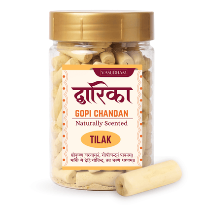Pet jar with yellow cap and vasudham gopi chandan pieces inside and dwarika chandan written on label