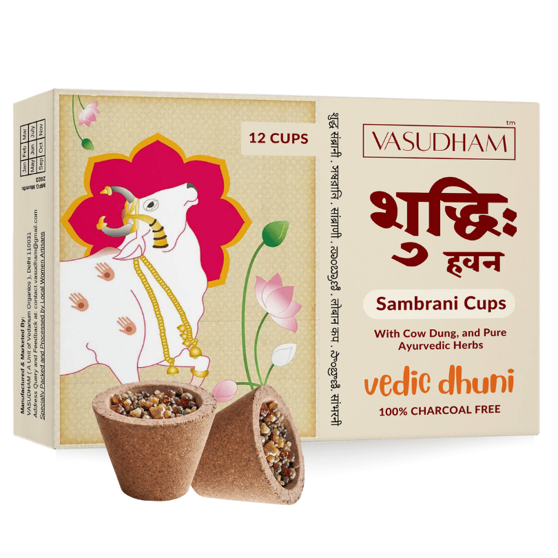 Vasudham Sambrani Cups box with illustrated cow and floral design, showing two prepared herbal cups in front on a white background.