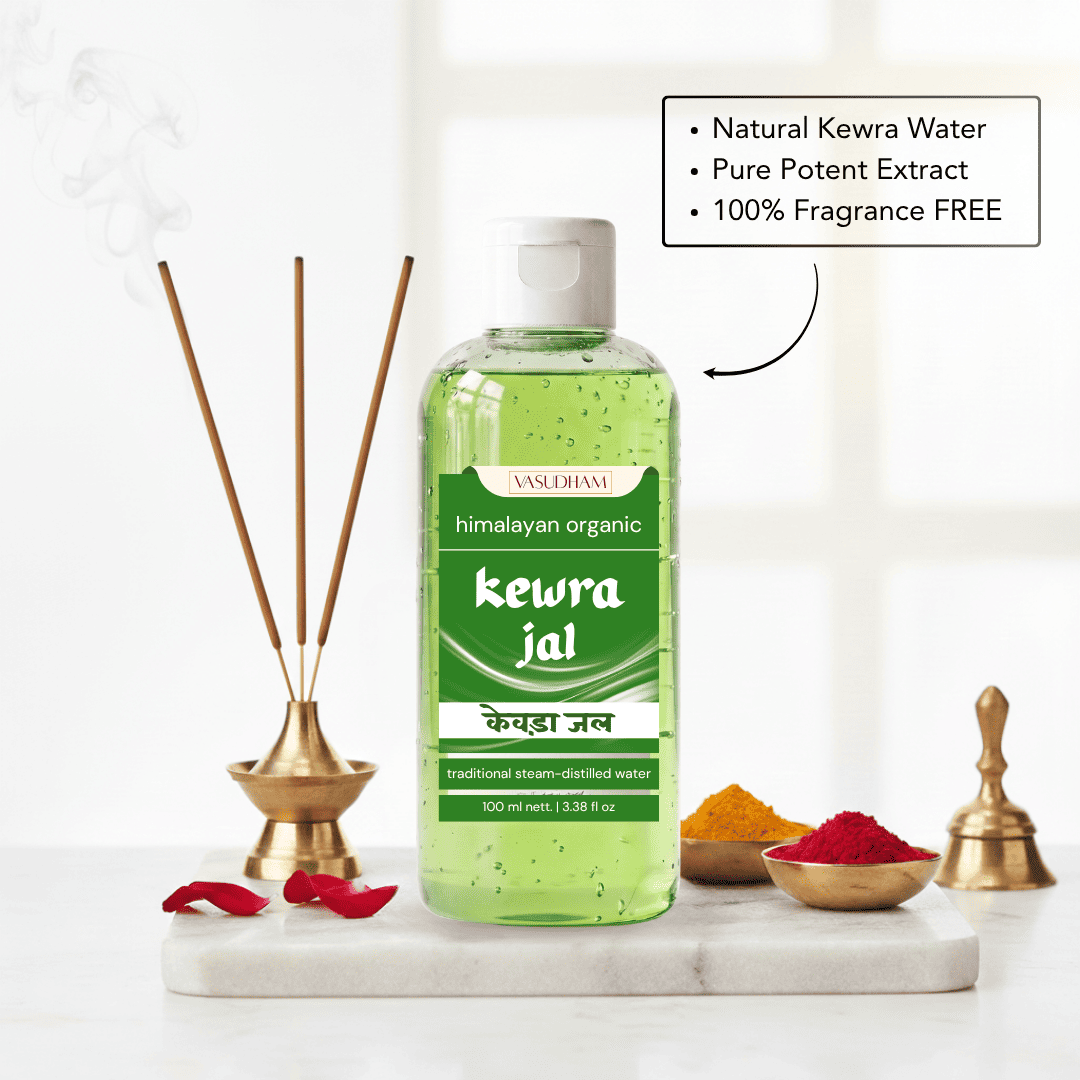 A bottle of Himalayan Kewra Jal essential oil diffuser liquid, filled with green liquid and featuring a white cap, displayed on a marble tray with incense sticks, brass bells, and spices against a bright, softly blurred background.