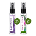 Two small clear spray bottles with black pump tops on a white background. The left bottle has a lavender floral label and the right bottle has a pink lotus floral label.