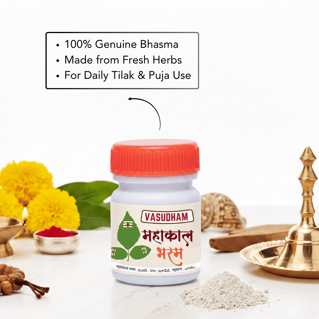 A white plastic bottle of Vasudham Mahakal Amrit with a red cap, surrounded by traditional Indian spiritual props including yellow marigold flowers, a brass lamp, and a small pile of powder, with a text overlay detailing its features.