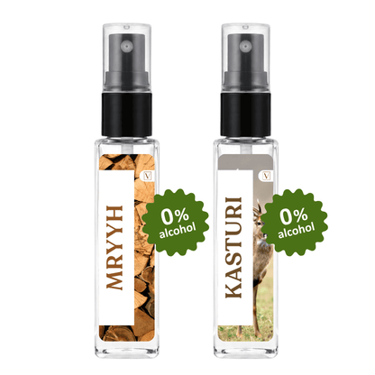 Two clear spray bottles with black pump tops on a white background. The left bottle has a white label with brown vertical text reading 'MRYYH' and a wood-chip photo, plus a green badge that says '0% alcohol'.
