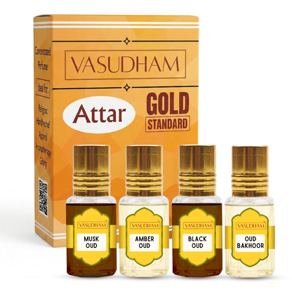 Vasudham Attar Gold Standard perfume oil set, featuring a golden-orange box and four small glass bottles with gold caps labeled Musk Oud, Amber Oud, Black Oud, and Oud Bakhoor.
