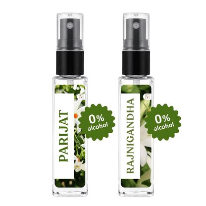 Two clear glass perfume spray bottles with black atomizers and white labels, shown side by side on a white background. The left bottle is labeled PARIJAT with a green 0% alcohol badge, and the right bottle is labeled RAJNIGANDHA with a green 0% alcohol badge.