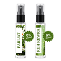Two clear glass perfume spray bottles with black atomizers, labeled 'PARIJAT' and 'RUH KEWRA', each with a green '0% alcohol' badge overlay, on a plain white background.