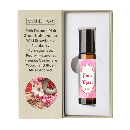 Vasudham Pink Muse essential oil roller bottle in its presentation box, featuring a pink label and a list of scents on the left side.