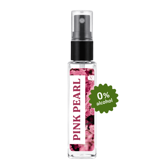 A clear glass perfume atomizer spray bottle with a black pump, featuring a pink floral label with the text 'PINK PEARL' and a green badge that reads '0% alcohol'.