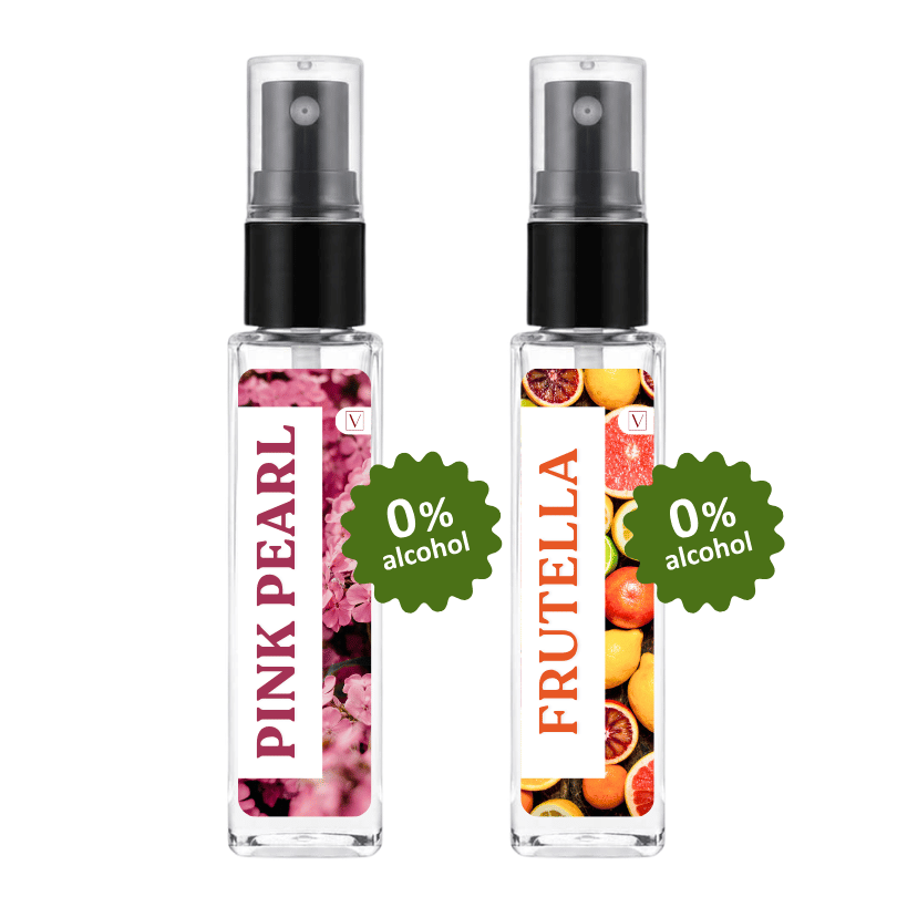 Two clear glass perfume spray bottles with black pumps on a white background. The left bottle has a white label with pink floral imagery and the text 'PINK PEARL' and '0% alcohol'.
