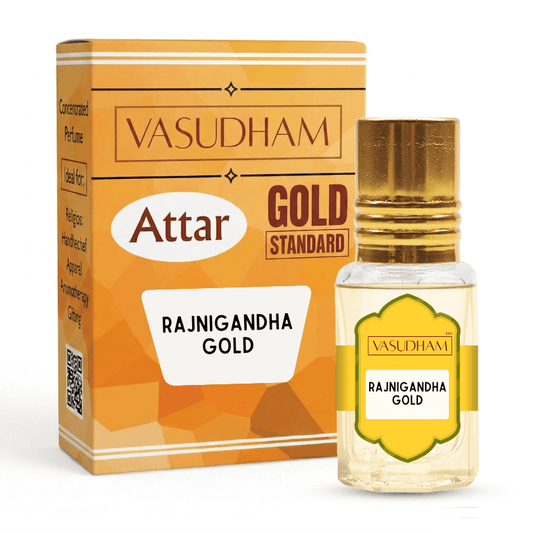 Vasudham Attar Gold Standard Rajnigandha Gold perfume bottle with a gold cap next to its orange and gold packaging box on a white background.