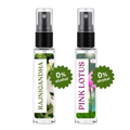 Two clear glass perfume atomizer bottles with black spray tops on a white background. The left bottle has a white label with green text reading RAJNIGANDHA and a white flower photo.