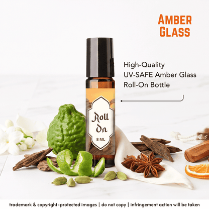 An 8 mL amber glass roll-on bottle with a black cap and a cream label reading 'Roll On 8 ML,' shown on a white surface with citrus, cinnamon, star anise, cardamom, and orange slices around it. Text on the image says 'AMBER GLASS' and 'High-Quality UV-SAFE Amber Glass Roll-On Bottle.