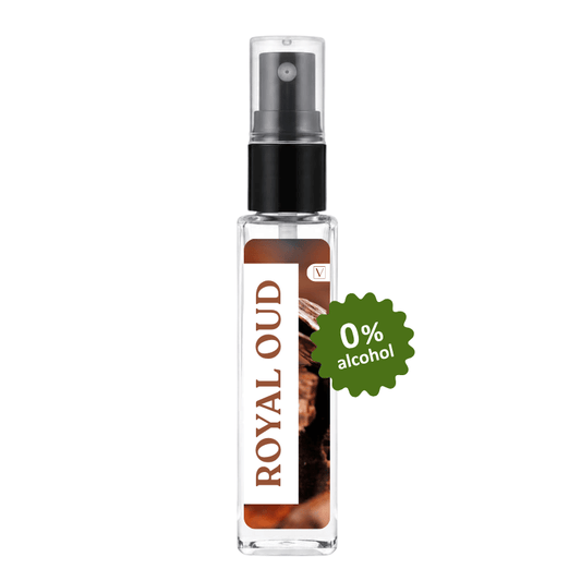 A clear glass perfume spray bottle with a black pump and a brown-and-white label reading 'ROYAL OUD'. A green badge on the right says '0% alcohol'.