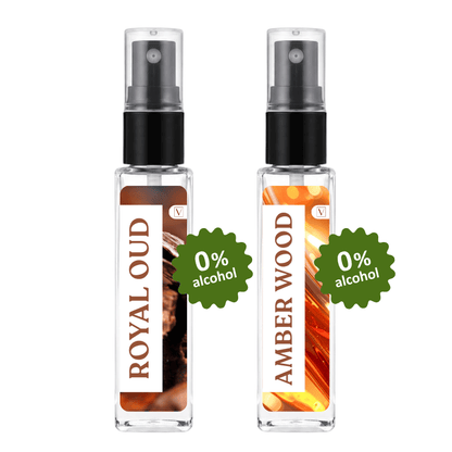 Two clear glass perfume spray bottles with black pumps, labeled ROYAL OUD and AMBER WOOD, shown side by side on a white background with green '0% alcohol' badges.