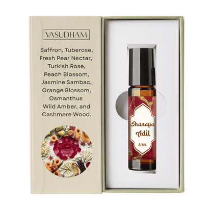 Vasudham Shanaya Adil 8ml essential oil roller bottle presented inside its white gift box next to its beige packaging insert.