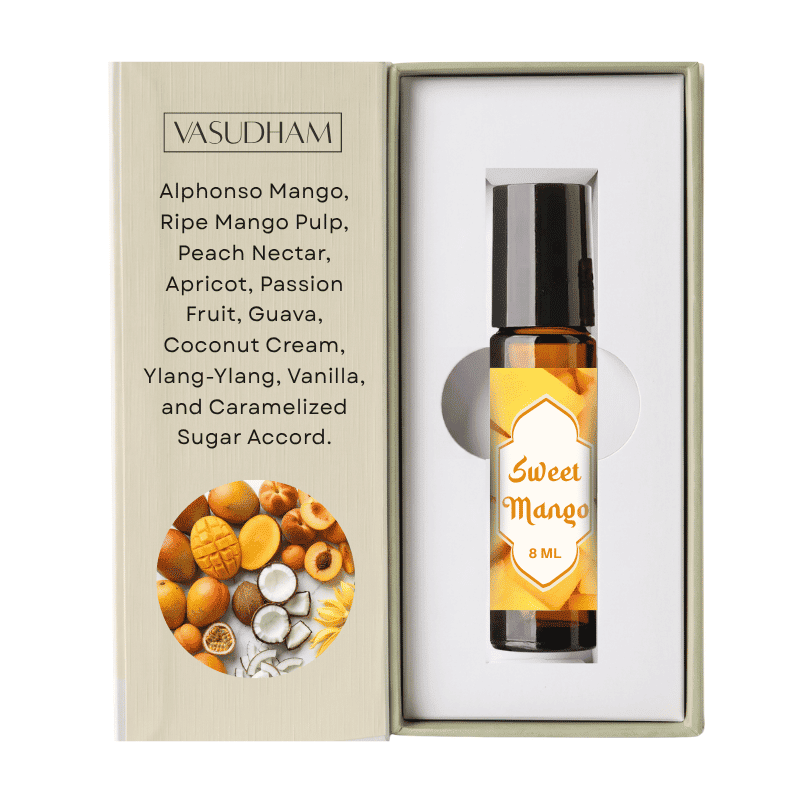 Vasudham Sweet Mango essential oil roller bottle in its open presentation box, showing the bottle next to the printed packaging insert.