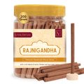 Jar of Rajnigandha dhoop sticks with a yellow lid and visible label.