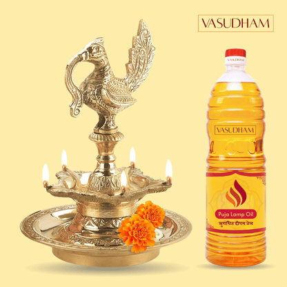 Decorative oil lamp with lit candles and a bottle of Vasudham Puja Lamp Oil on a yellow background.