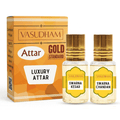 Vasudham Attar Luxury Attar set featuring a gold-colored box and two small glass bottles with gold caps, labeled Swarna Kesar and Swarna Chandan.